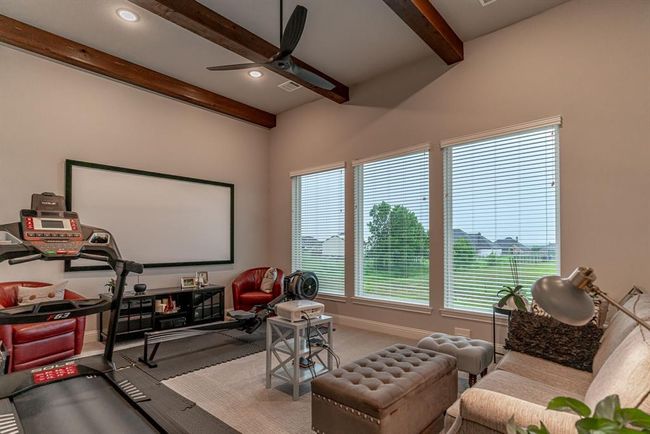 Carpeted bedroom with ceiling fan and multiple windows | Image 29