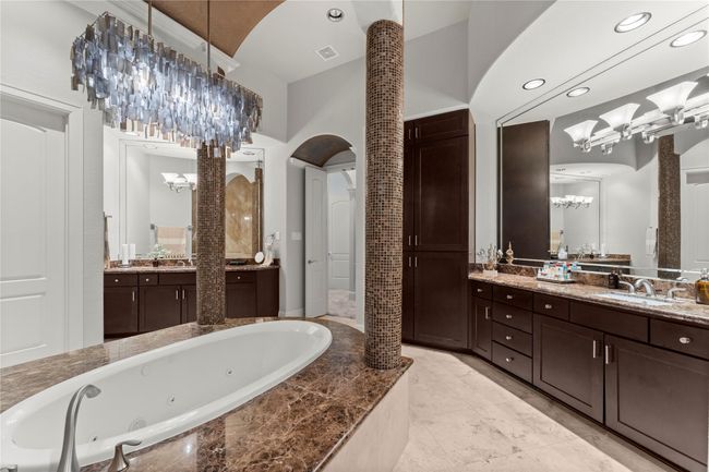 The bath features elevated countertops, dual sinks, and two spacious walk-in closets, offering both style and functionality... | Image 29