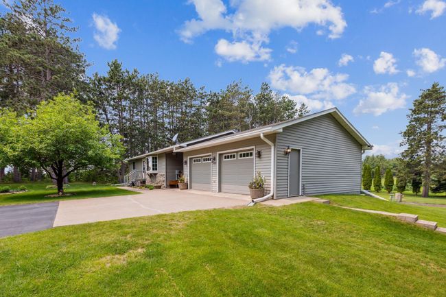 Attached 2 car garage with 2 service doors, one on the side, one in the rear of home and steps to the pole building. | Image 40