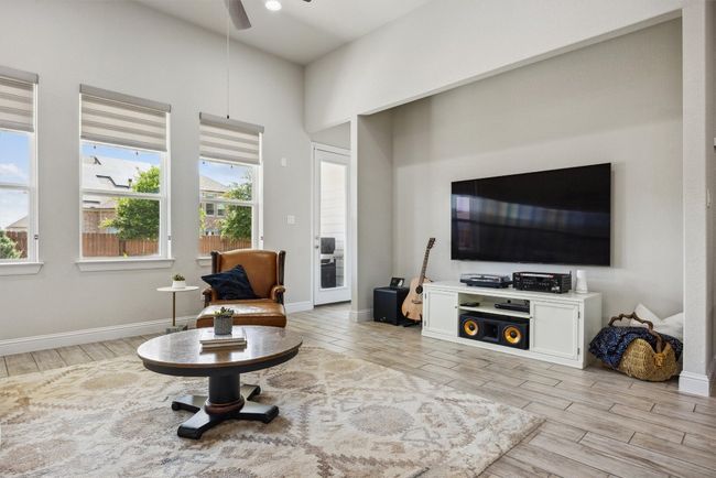 Living area featuring light wood-type flooring and ceiling fan | Image 12