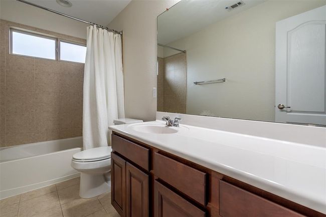 Bathroom featuring vanity, tile patterned flooring, and shower / bath combo with shower curtain | Image 18