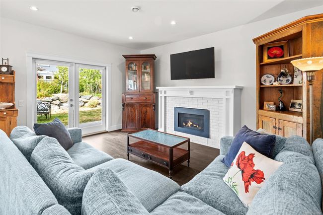 Living area featuring recessed lighting, wood finished floors, and a brick fireplace | Image 10