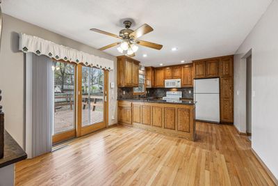 Beautiful hardwood flooring, completely updated kitchen with granite, all new tall cabinets, newer sliding glass door and windows throughout, new dishwasher, recessed lights, tile backsplash. | Image 3