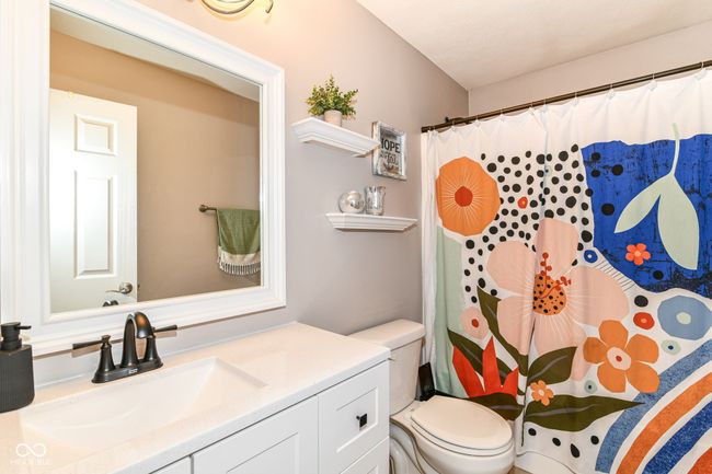 full bathroom featuring toilet, vanity, and a shower with curtain | Image 20