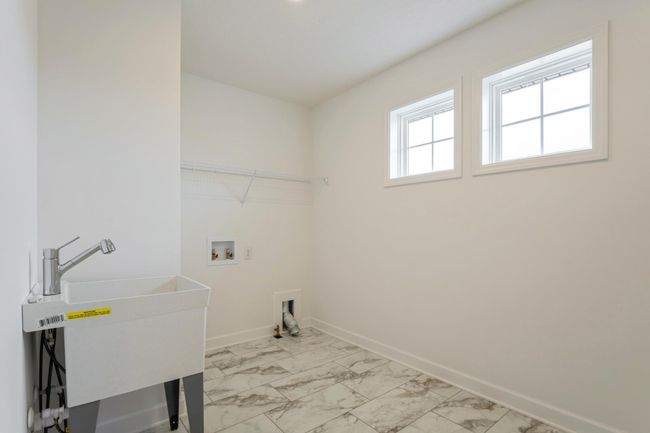 Photo is of the actual home. Centrally located on the upper level, along with the four bedrooms, this laundry room is sure to provide the ultimate convenience. | Image 15