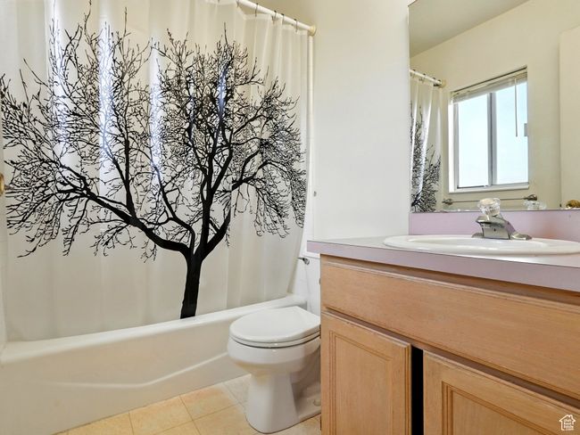 Bathroom with vanity, tile patterned floors, and shower / tub combo | Image 21