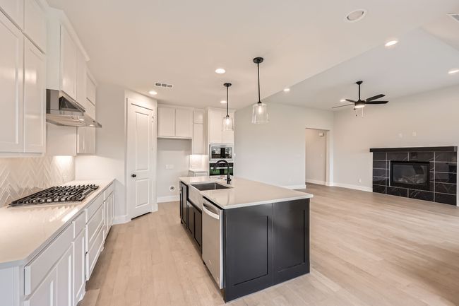 Kitchen featuring visible vents, a ceiling fan, appliances with stainless steel finishes, under cabinet range hood, and white cabinetry | Image 11