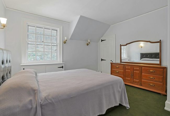 Bedroom with dark colored carpet and lofted ceiling | Image 25