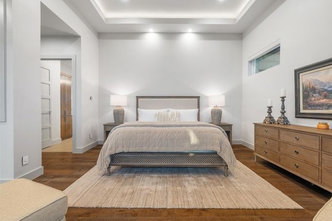 Primary Bedroom with baseboards, a raised ceiling, recessed lighting, and dark wood-style floors | Image 14