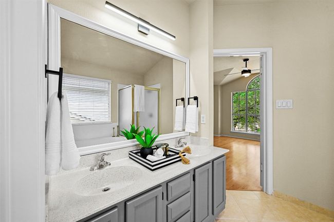 Full bathroom with double vanity, a stall shower, a ceiling fan, and tile patterned floors | Image 23