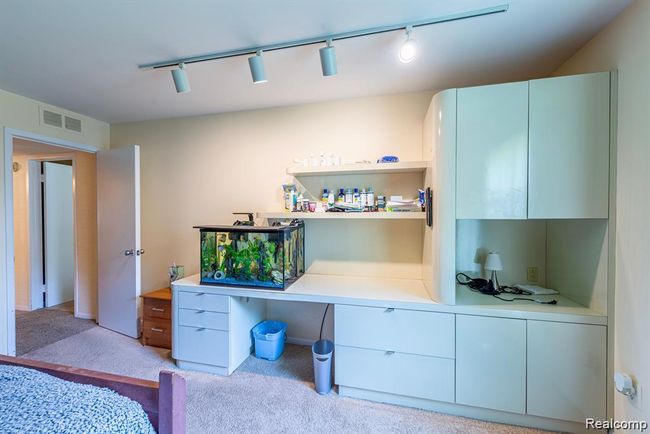 Bedroom featuring track lighting and light carpet | Image 27