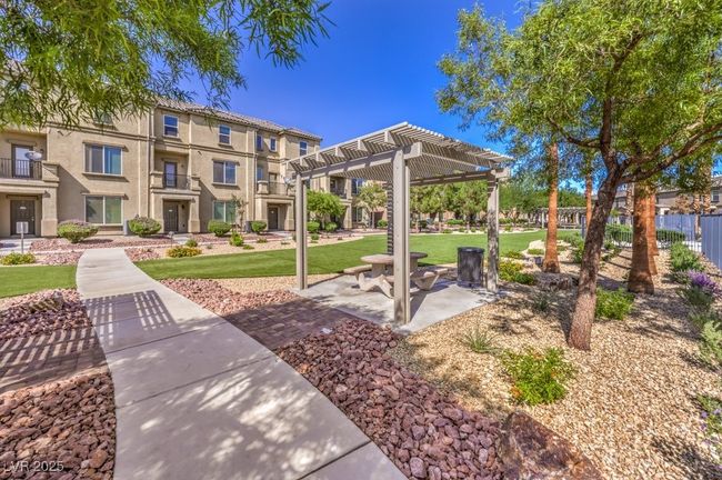 View of property's community with a pergola and a lawn | Image 25