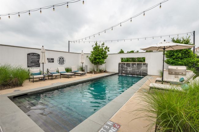 Gorgeous pool with water all at the club house with lounge chairs and BBQ grill | Image 36