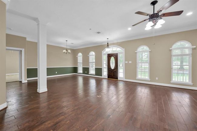 Dining Room with front door on the right and entrance to the Primary Bedroom through the door way on the left. | Image 12