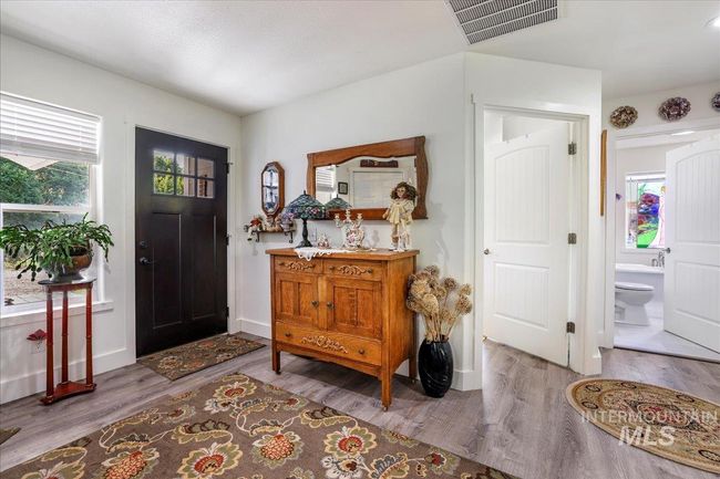 Front entry, showing doors to second bedroom and bathroom. | Image 7