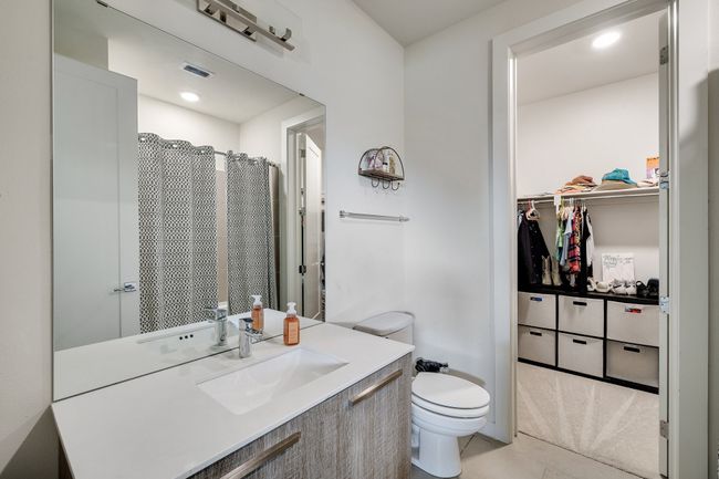 Full bathroom featuring vanity, tile patterned flooring, and a walk in closet | Image 31
