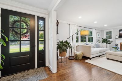 Gorgeous new doors, entryway and windows fill the home with natural light. | Image 1