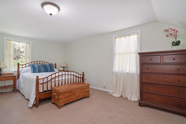 Bedroom featuring light carpet and vaulted ceiling | Image 12