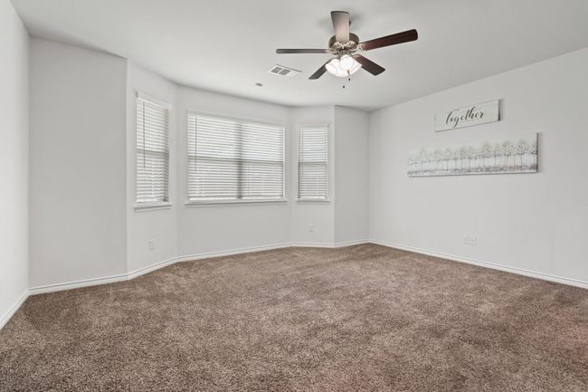 Large Primary Bedroom on First Floor with a ceiling fan and baseboards | Image 16
