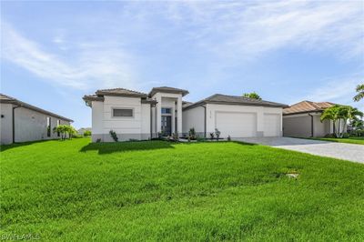 View of front of home featuring a garage and a front yard | Image 2