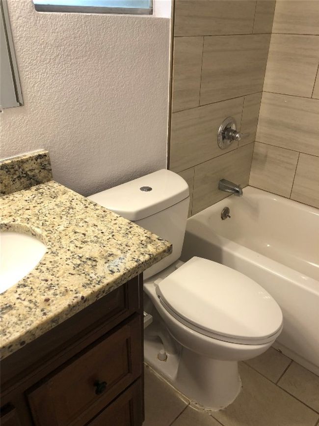 Full bath featuring vanity, tile patterned flooring, and bathtub / shower combination | Image 15