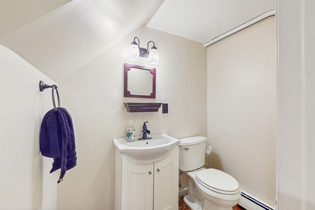 Lower Level Powder Room (1/2 bathroom) with baseboard heating, vanity, and toilet. | Image 31