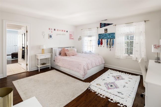 Bedroom with large closets and dark hardwood flooring | Image 26