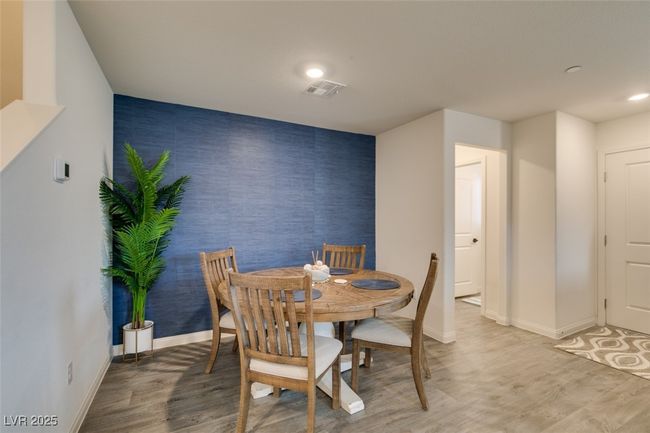 Dining space featuring light wood-type flooring, baseboards, an accent wall, recessed lighting, and visible vents | Image 18