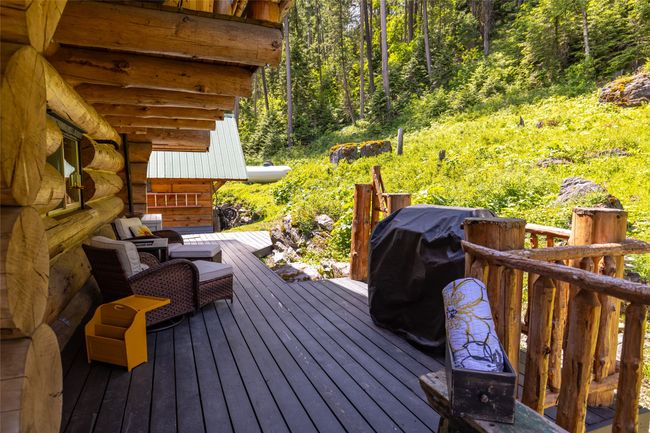 Deck featuring a view of trees and area for grilling | Image 105