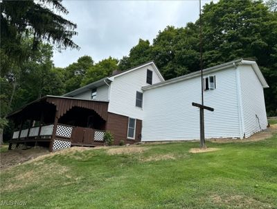 Rear view of property with a deck and a yard | Image 2