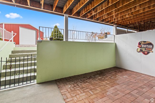 View of patio featuring a garage and an outbuilding | Image 78