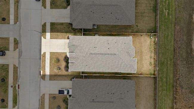 This home sits on a large lot with ample yard space in front and the back, lush landscaping and a well-maintained yard. Plenty of space to accommodate guest parking and situated on a quiet street in the Sunterra community. | Image 5