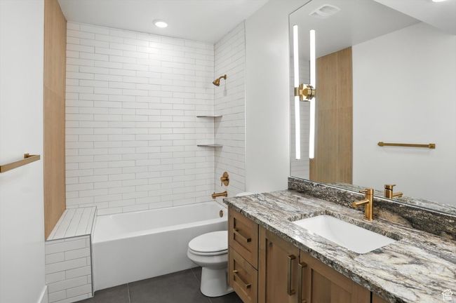 Full bathroom featuring vanity, tile patterned floors, and shower / tub combination | Image 46