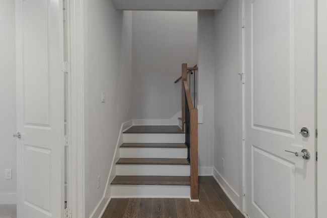 Staircase with baseboards and wood finished floors | Image 9