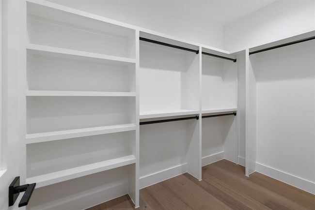 Walk in closet featuring dark wood-type flooring | Image 28