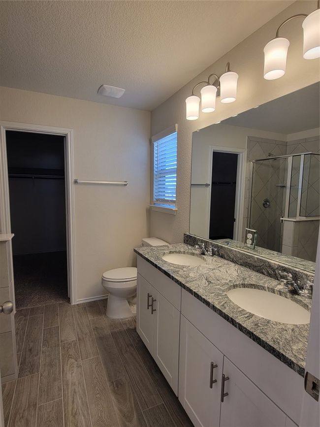 Full bathroom with a sink, a stall shower, a textured ceiling, and wood tiled floor | Image 20