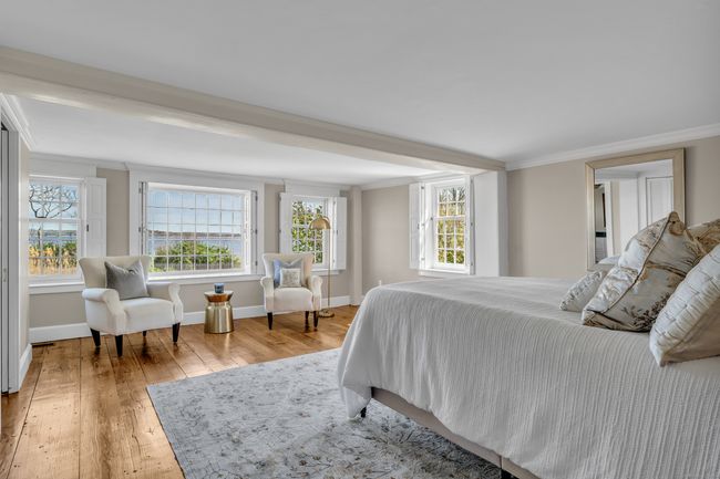 First Floor Primary Suite is Designed With Grace And Style...offering expansive views of North Cove | Image 19