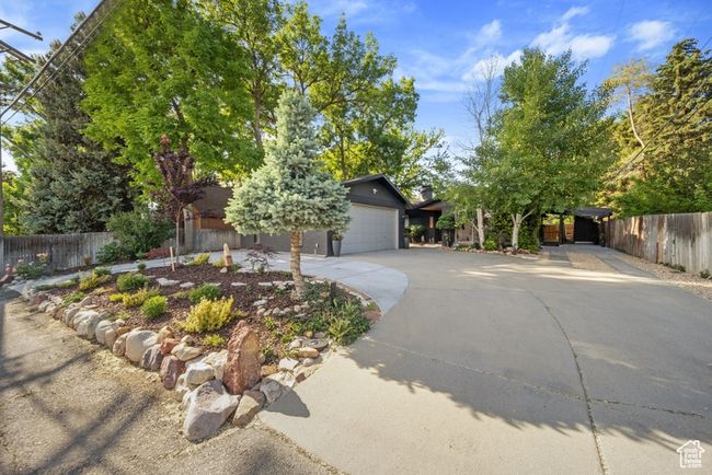 View of front facade featuring concrete driveway and a garage | Image 28