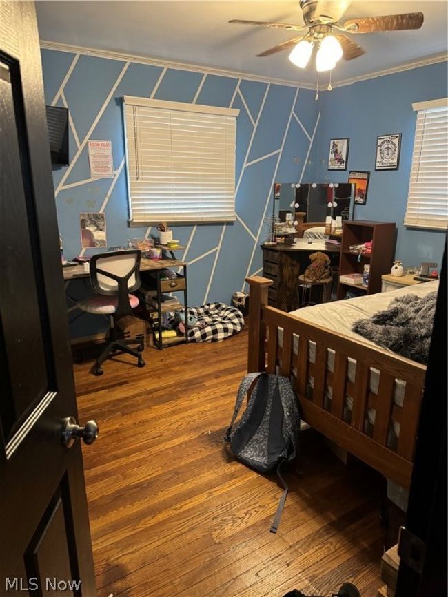 Bedroom with ornamental molding, ceiling fan. | Image 7