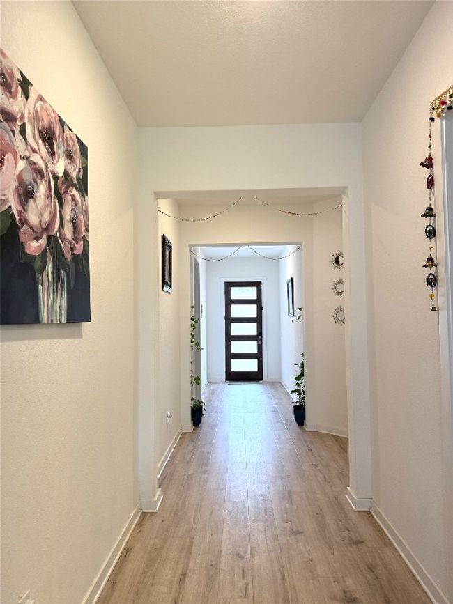 Hall featuring light wood-type flooring and baseboards | Image 4