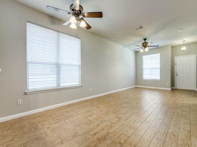 Spare room featuring light wood-type flooring and ceiling fan | Image 2