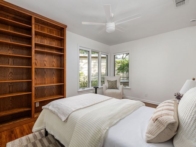 Bedroom with a closet, wood flooring, and a ceiling fan | Image 23