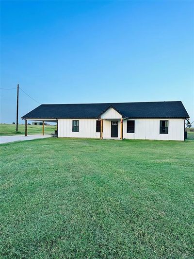 View of 1st Home, front of house with a carport and a front yard | Image 1