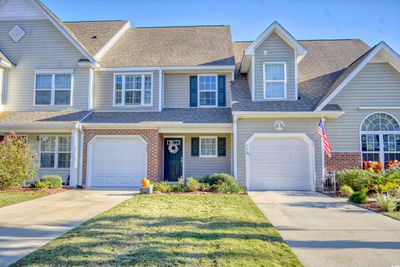 View of front of property with a garage and a front lawn | Image 1