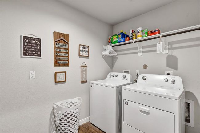 Spacious laundry room with shelf and drying space and plenty of room for additional storage space if needed | Image 12