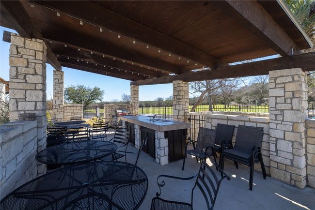 View of patio / terrace with outdoor dry bar, outdoor dining area, and fence | Image 25