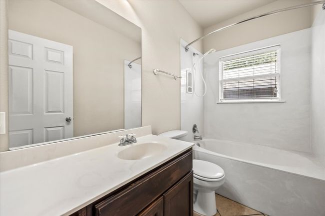 Full bathroom with tile patterned floors, toilet, shower / tub combination, and vanity | Image 21