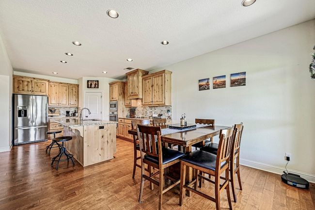 Dining space featuring light wood-style floors and recessed lighting | Image 15