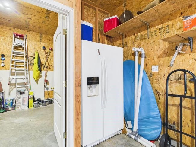 Garage featuring white fridge with ice dispenser | Image 73