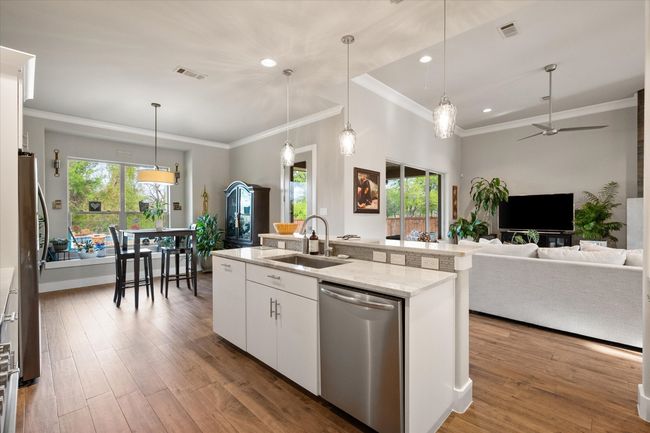Island with sink, sitting area and view of back yard | Image 10